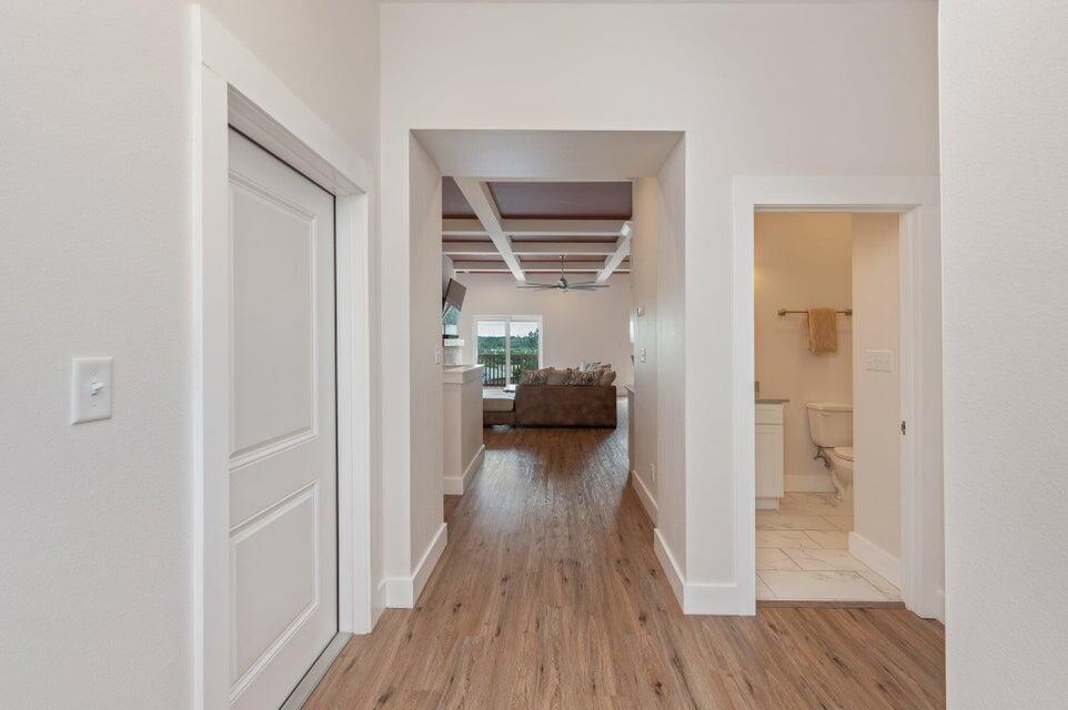 508 Harborview Circle Niceville, FL 32578 - Photo 7 of 60 a view of a hallway with wooden floor a bedroom and a bed