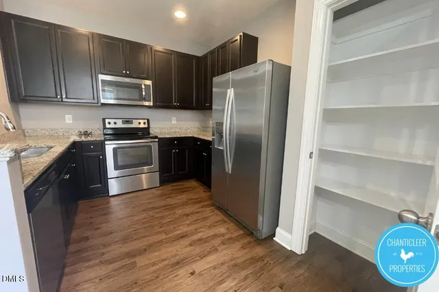 a kitchen with stainless steel appliances granite countertop a refrigerator stove and microwave