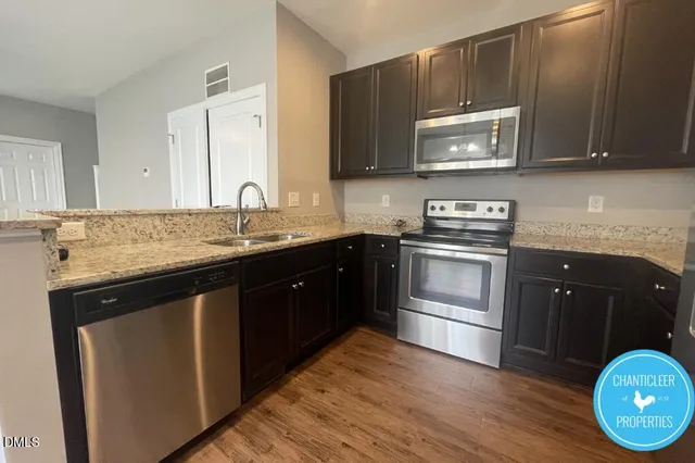 a kitchen with a sink stove and microwave