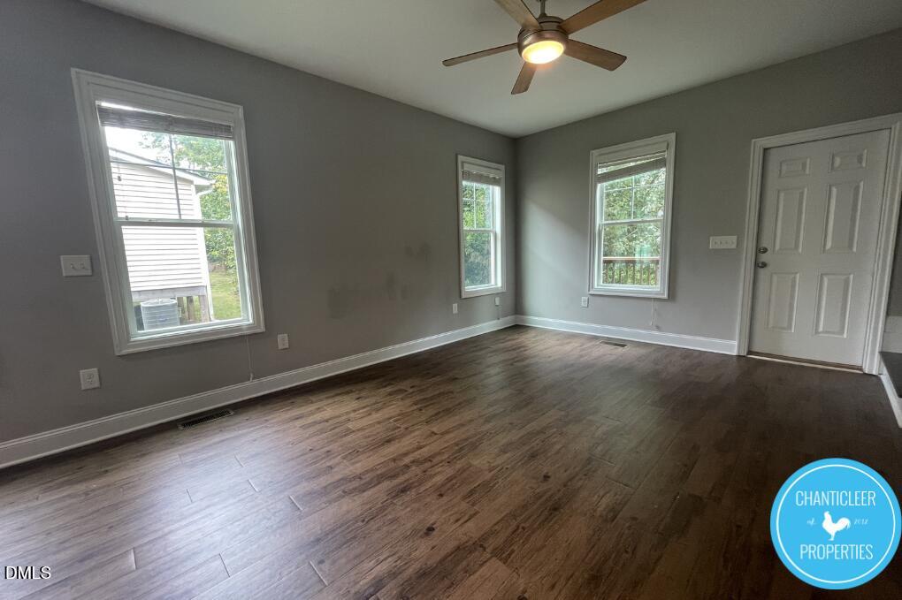 912 Chaney Road, Unit 100 Raleigh, NC 27606 - Photo 6 of 18 a view of an empty room with wooden floor and a window