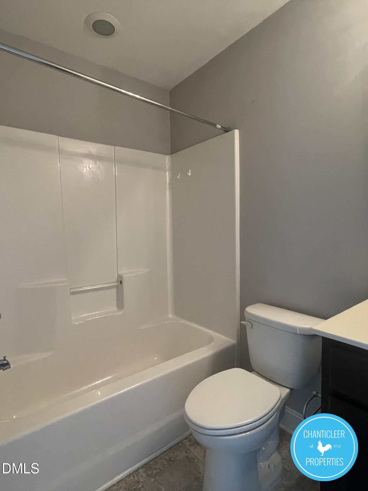 912 Chaney Road, Unit 100 Raleigh, NC 27606 - Photo 9 of 18 a white toilet sitting next to a bath tub