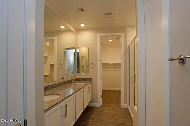 a bathroom with a granite countertop sink and a mirror