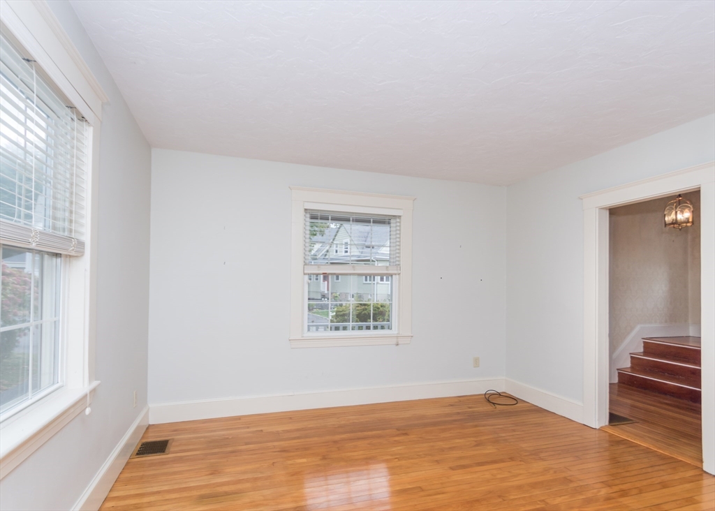 37 Summit Street Waltham, MA 02451 - Photo 12 of 29 an empty room with wooden floor and windows