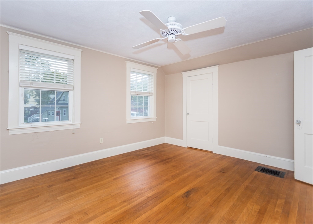 37 Summit Street Waltham, MA 02451 - Photo 15 of 29 a view of an empty room with a window and wooden floor