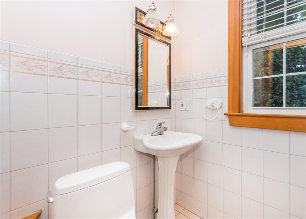 37 Summit Street Waltham, MA 02451 - Photo 23 of 29 a bathroom with a sink a mirror and a toilet