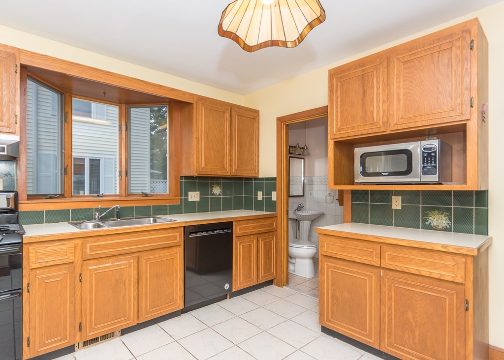 37 Summit Street Waltham, MA 02451 - Photo 7 of 29 a kitchen with cabinets and window
