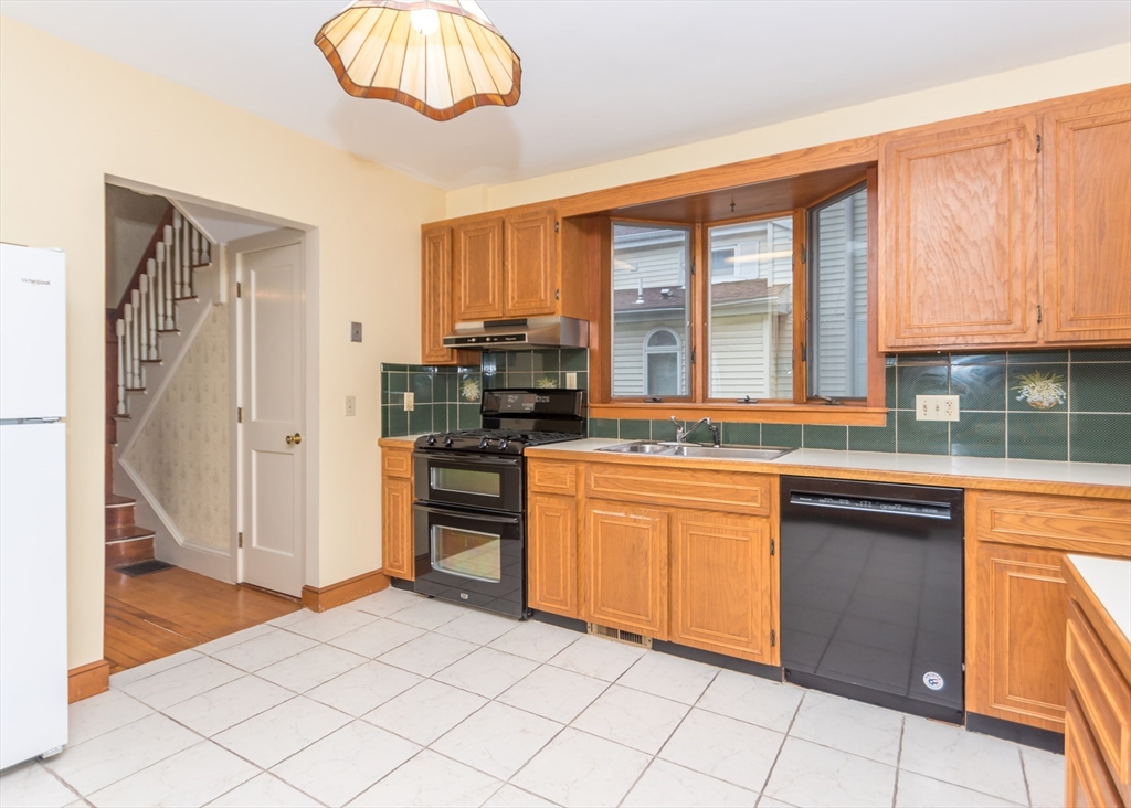 37 Summit Street Waltham, MA 02451 - Photo 10 of 29 a kitchen with stainless steel appliances granite countertop a stove and a sink