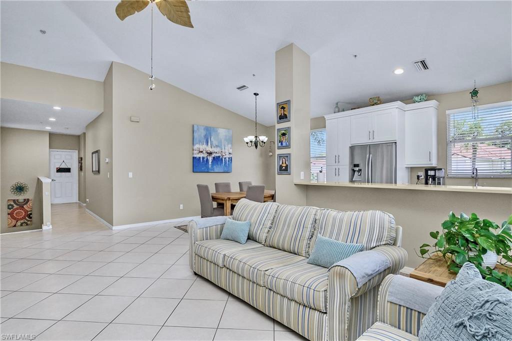 680 Lalique Circle, Unit 1205 Naples, FL 34119 - Photo 11 of 32 a living room with furniture and a large window