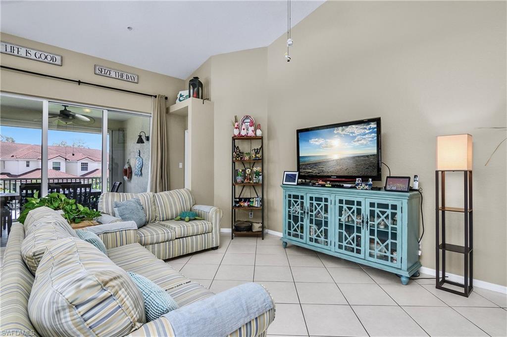 680 Lalique Circle, Unit 1205 Naples, FL 34119 - Photo 12 of 32 a living room with furniture and a flat screen tv