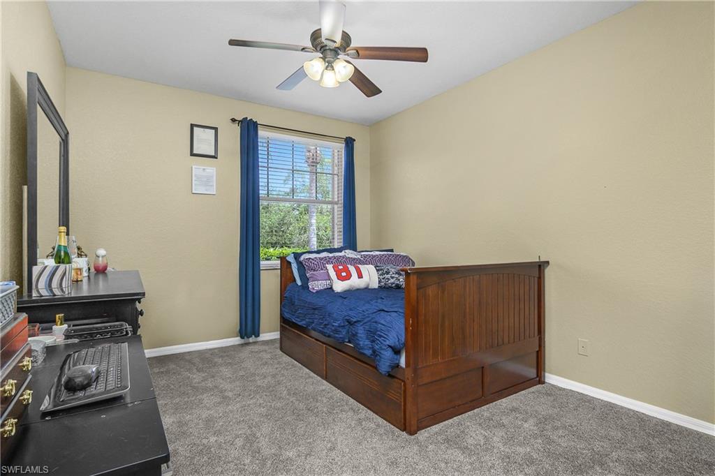 680 Lalique Circle, Unit 1205 Naples, FL 34119 - Photo 15 of 32 a bed room with a bed and a window