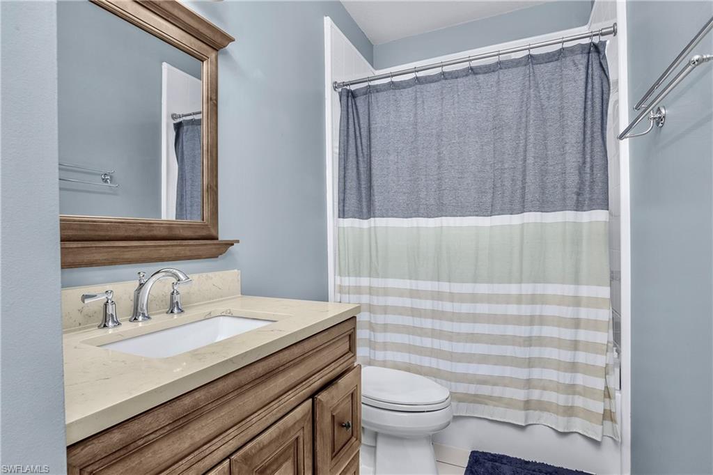 680 Lalique Circle, Unit 1205 Naples, FL 34119 - Photo 17 of 32 a bathroom with a sink a toilet and shower