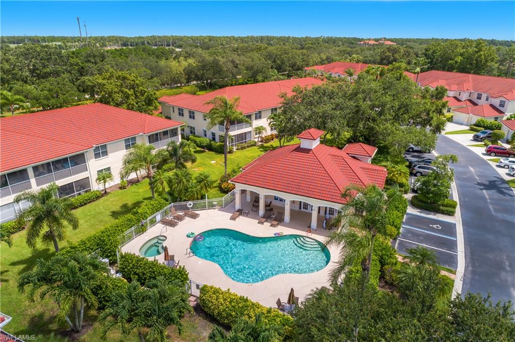 680 Lalique Circle, Unit 1205 Naples, FL 34119 - Photo 18 of 32 an aerial view of house with yard and lake view