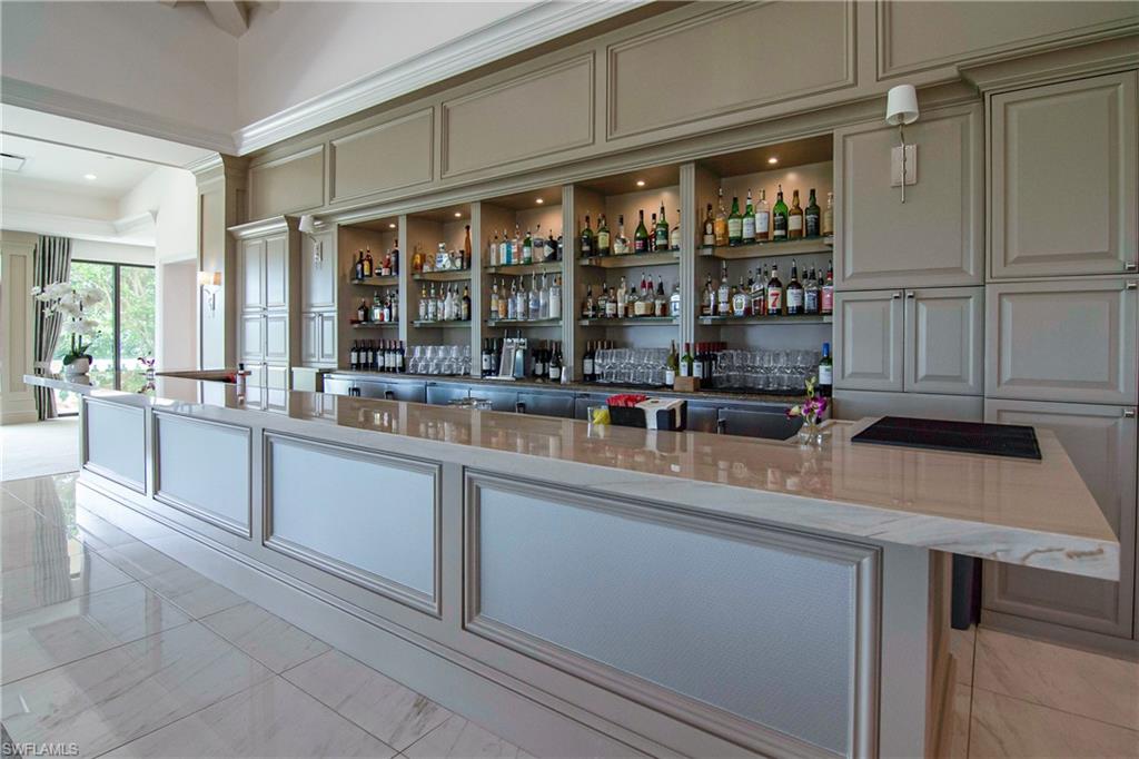 680 Lalique Circle, Unit 1205 Naples, FL 34119 - Photo 31 of 32 a kitchen with stainless steel appliances a sink and cabinets