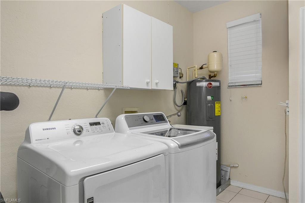680 Lalique Circle, Unit 1205 Naples, FL 34119 - Photo 32 of 32 a utility room with dryer and washer