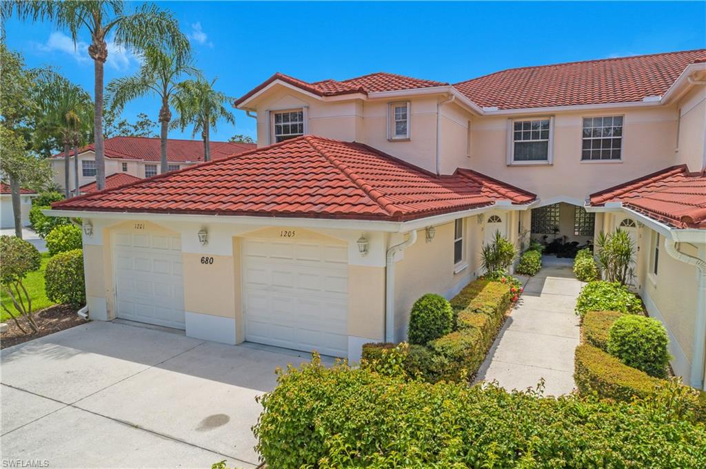 680 Lalique Circle, Unit 1205 Naples, FL 34119 - Photo 4 of 32 a front view of a house with garden