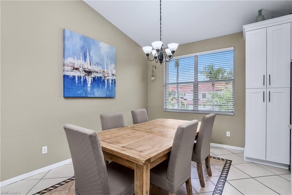 680 Lalique Circle, Unit 1205 Naples, FL 34119 - Photo 8 of 32 a view of a dining room with furniture window and chandelier