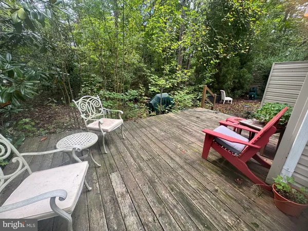 a wooden bench sitting in the middle of a backyard