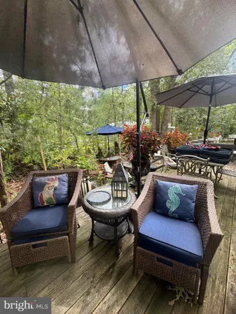 a outdoor sitting area with furniture and umbrella