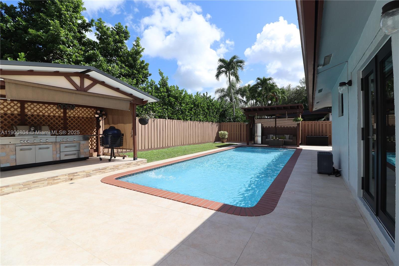 a view of a backyard with a tub and wooden fence