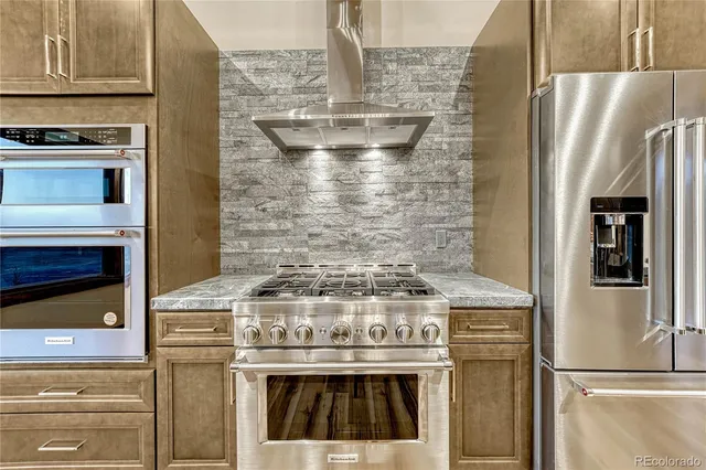 a stove top oven sitting inside of a kitchen