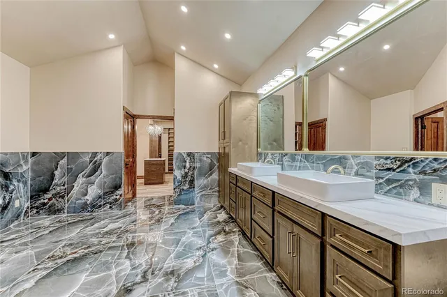 a bathroom with a double vanity sink and a mirror