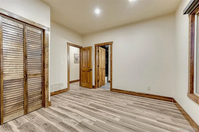 a view of a room with wooden floor and window