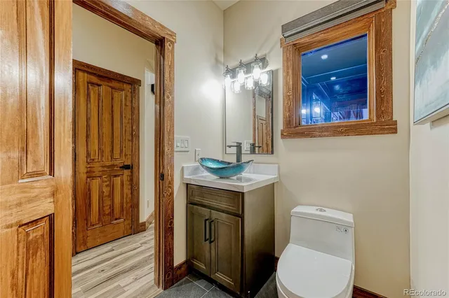 a bathroom with a toilet a sink and mirror