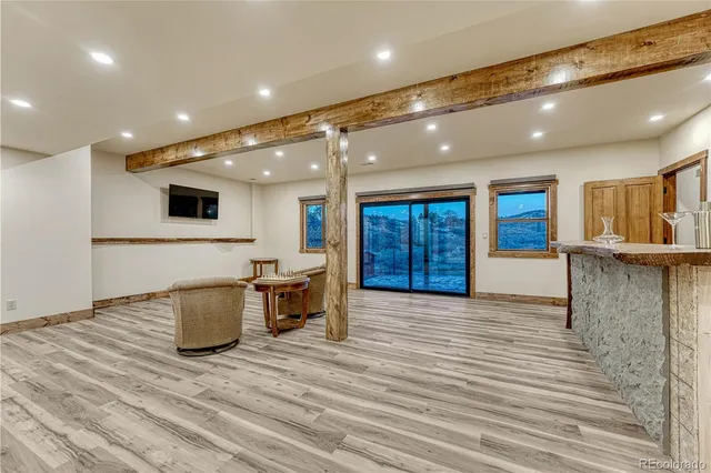 a view of a big room with wooden floor and windows