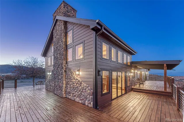 a view of a balcony with wooden floor and iron stairs