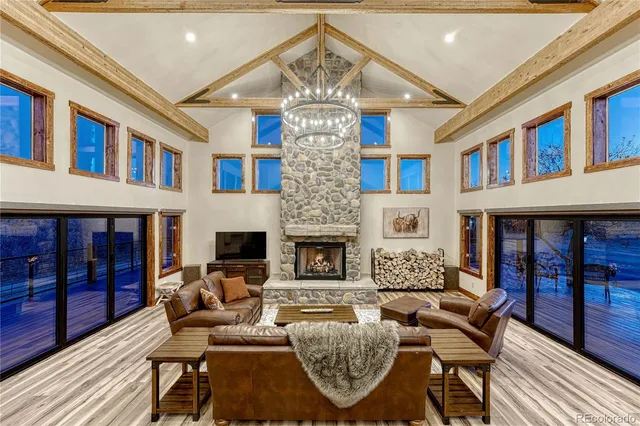 a living room with fireplace furniture and a wooden floor