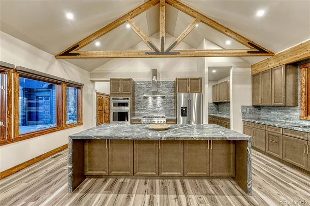 a view of a kitchen with granite countertop a sink and a wooden floor