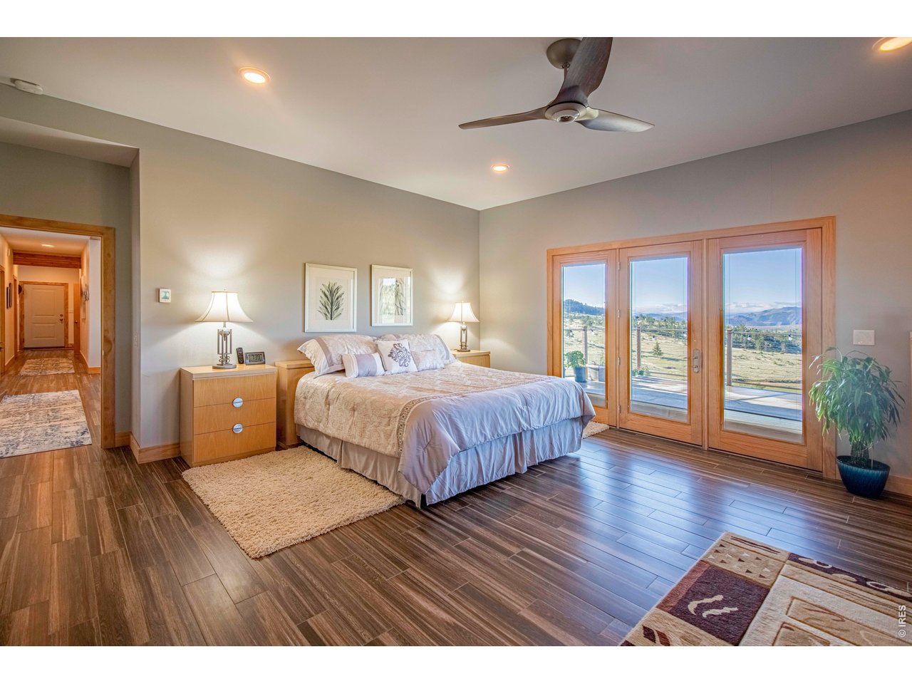 91 Eagle Rising Place Livermore, CO 80536 - Photo 13 of 38 a bedroom with a large bed and a wooden floor