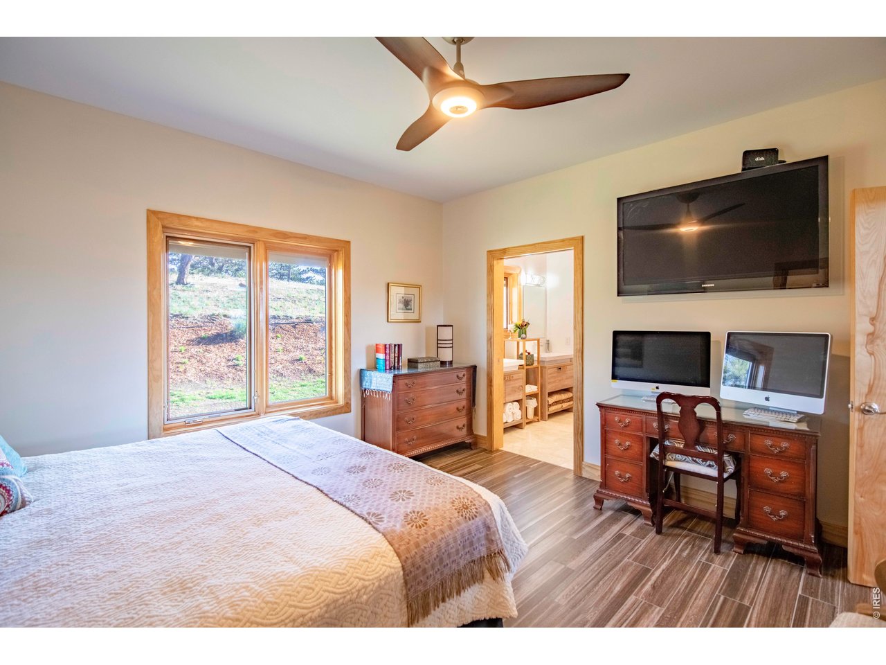 91 Eagle Rising Place Livermore, CO 80536 - Photo 16 of 38 a bedroom with a bed and a flat screen tv