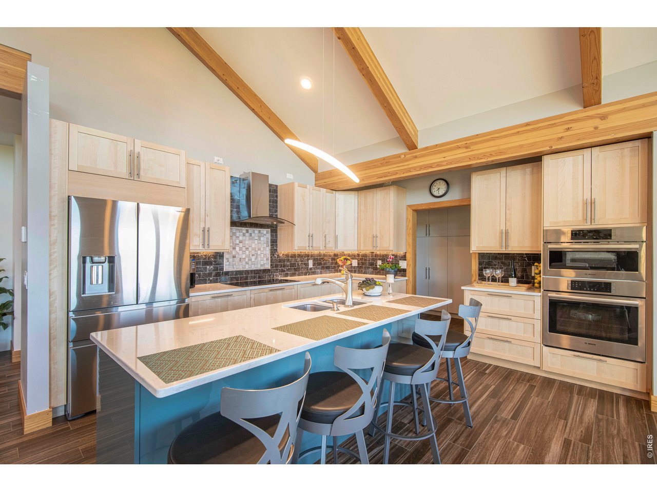 91 Eagle Rising Place Livermore, CO 80536 - Photo 5 of 38 a kitchen with sink cabinets dining table and chairs
