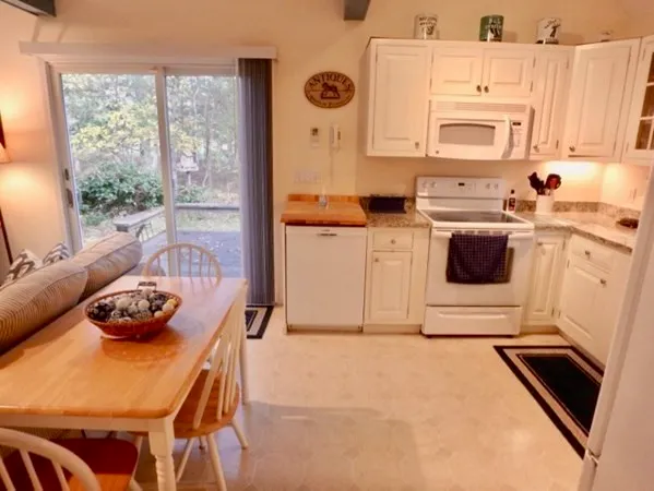 a kitchen with stainless steel appliances a stove a sink a cabinets and a window