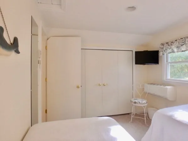 a bedroom with a bed and a flat screen tv