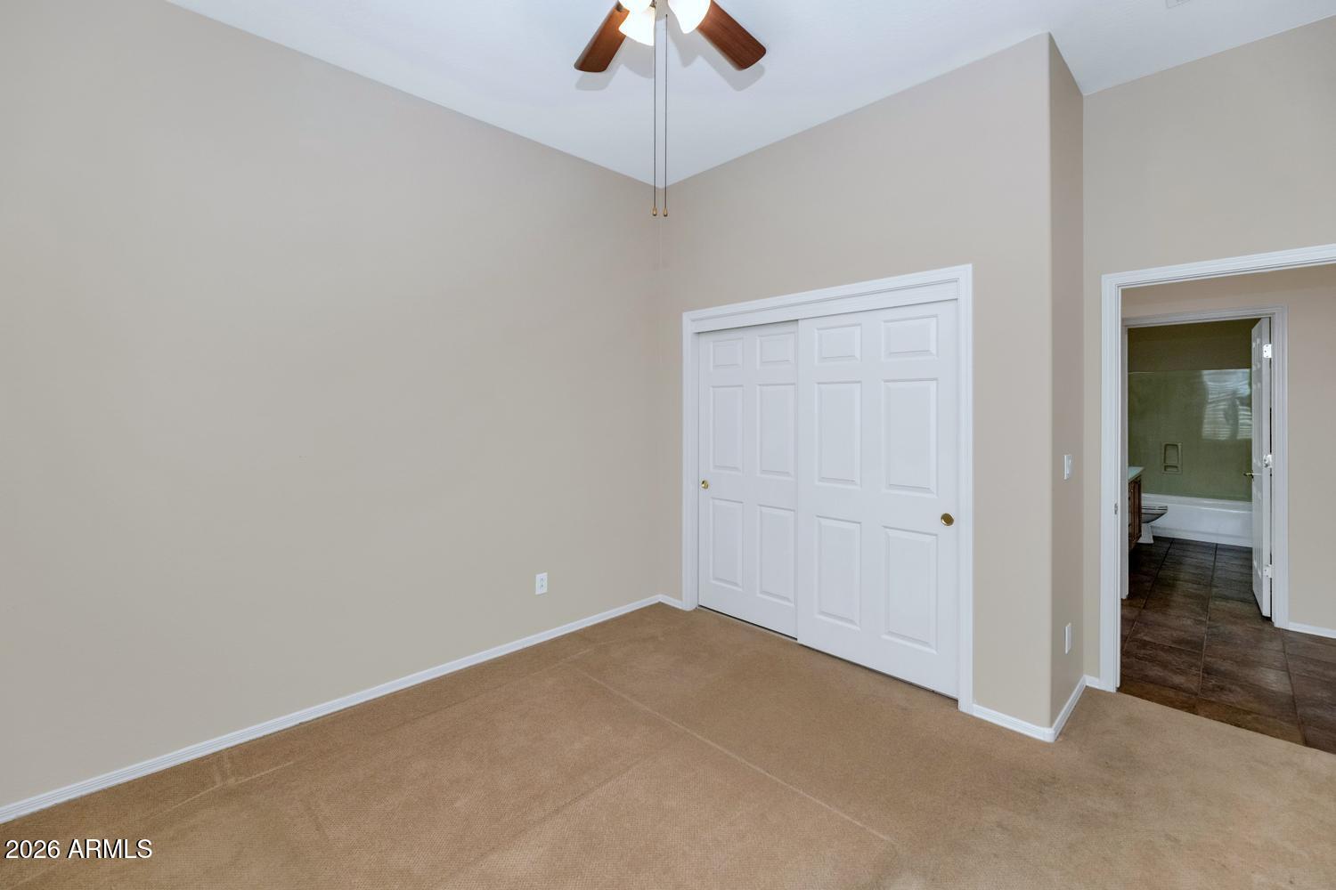 41123 North River Bend Road Phoenix, AZ 85086 - Photo 23 of 45 an empty room with closet and chandelier fan