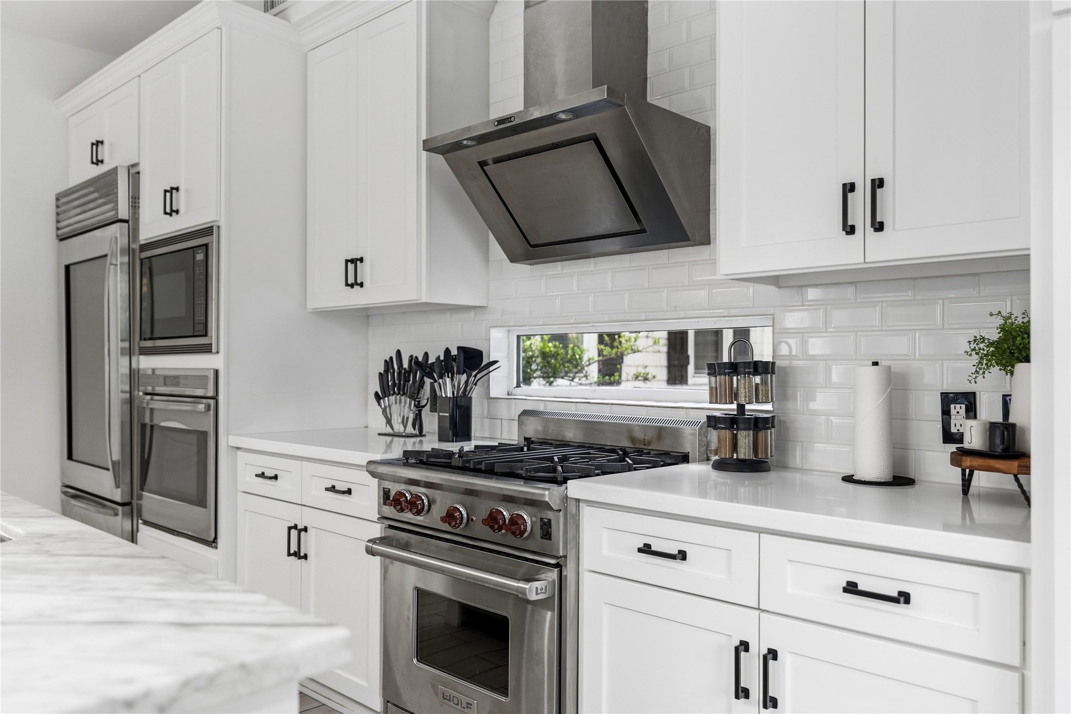 2025 Colquitt Street, Unit A Houston, TX 77098 - Photo 12 of 40 a kitchen with stainless steel appliances granite countertop white cabinets and white stove