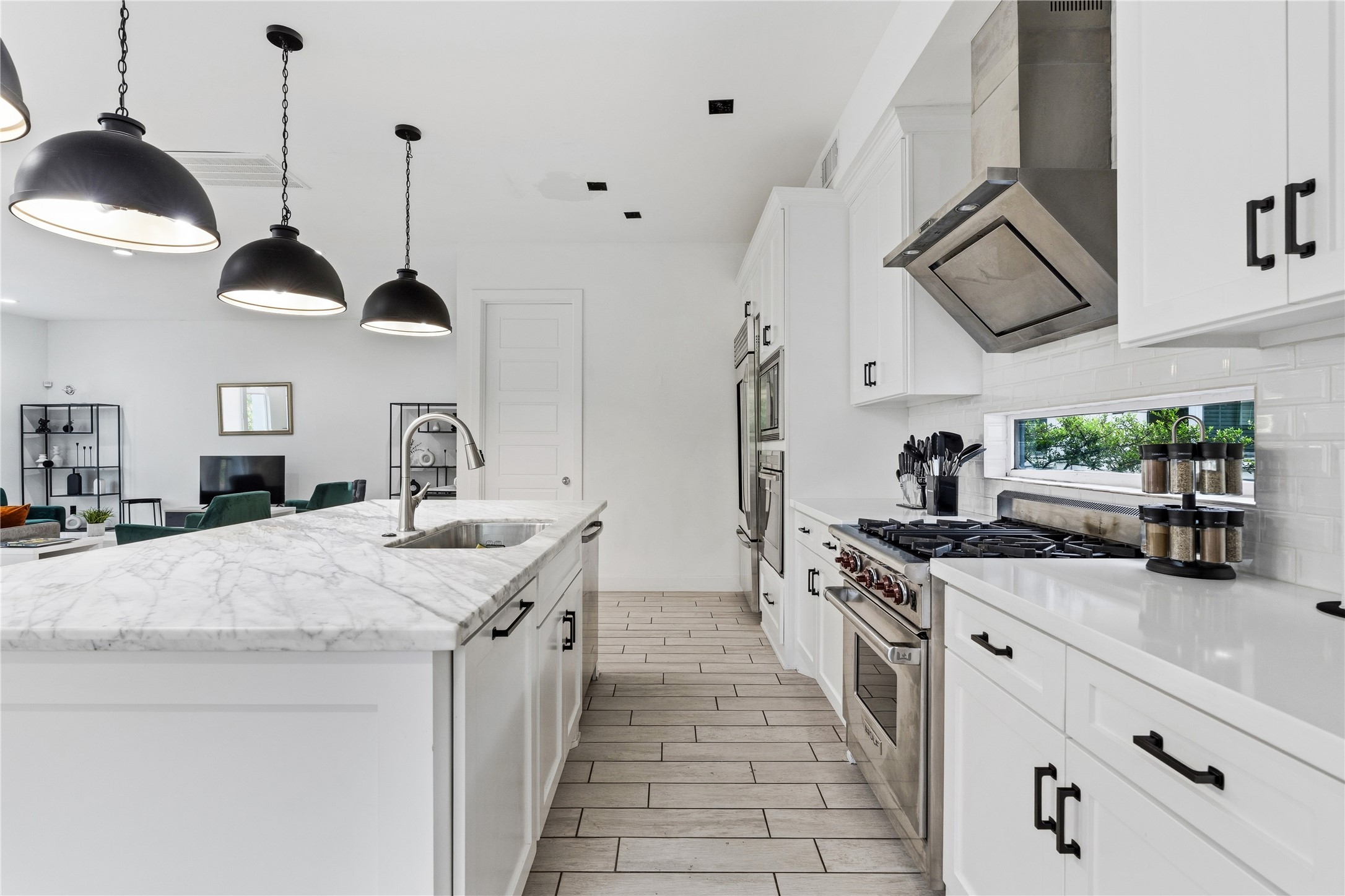 2025 Colquitt Street, Unit A Houston, TX 77098 - Photo 13 of 40 a kitchen with stainless steel appliances a stove a sink and a refrigerator