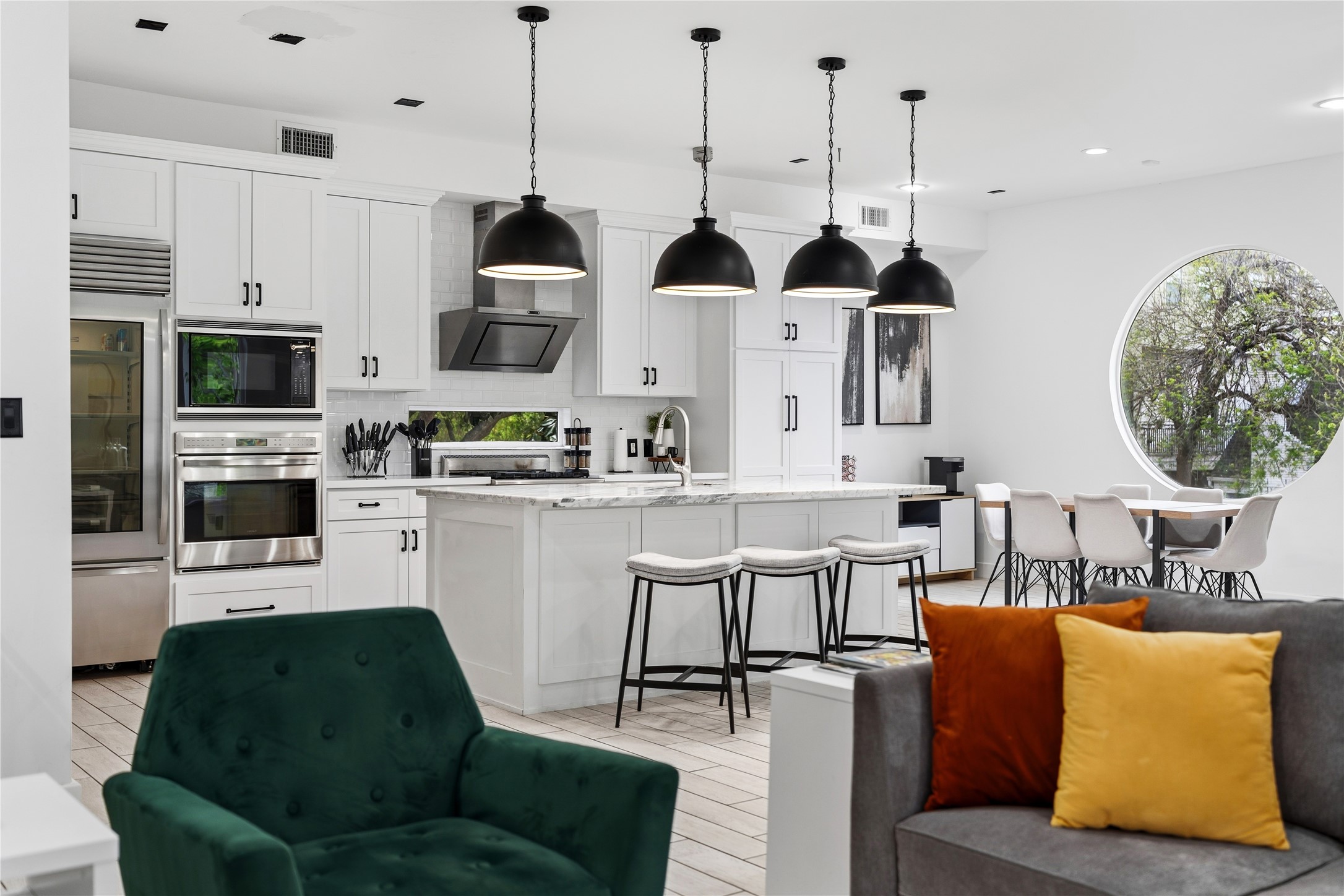 2025 Colquitt Street, Unit A Houston, TX 77098 - Photo 21 of 40 a living room with stainless steel appliances kitchen island granite countertop a living room a couch and a view of living room