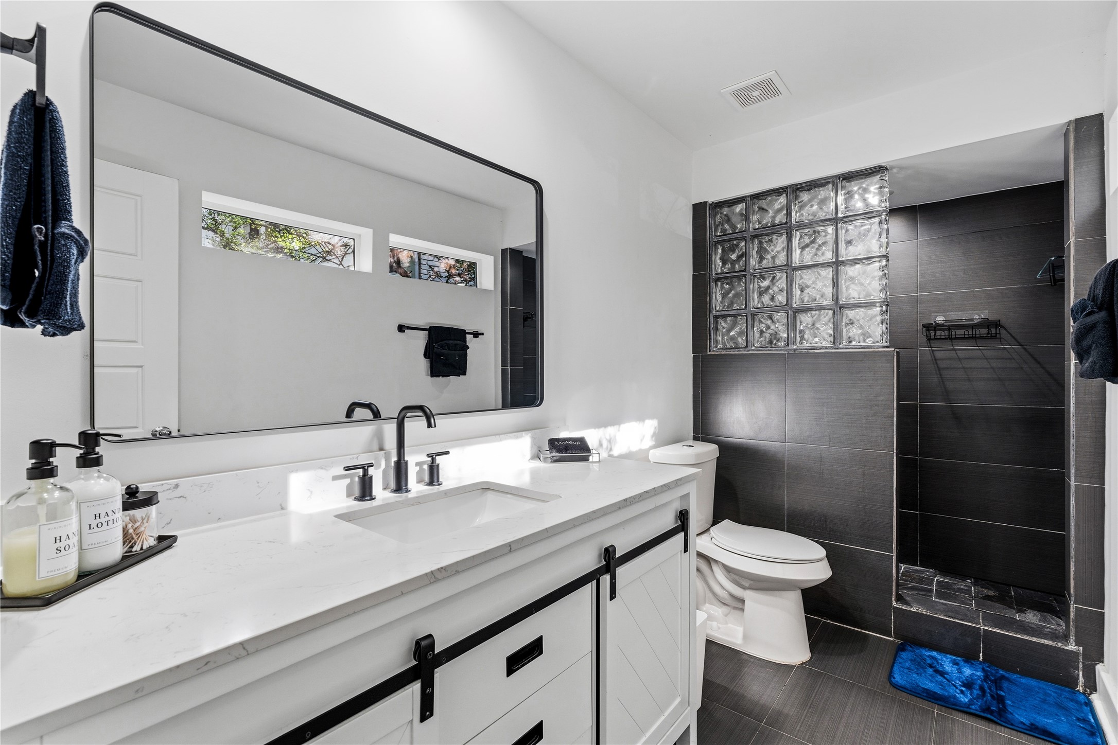 2025 Colquitt Street, Unit A Houston, TX 77098 - Photo 6 of 40 a bathroom with a sink a toilet and shower