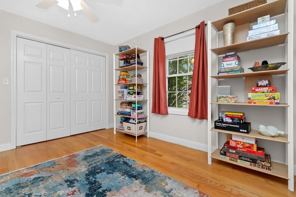 29 Spruce Street, Unit 23 Waltham, MA 02453 - Photo 16 of 26 a living room with lots of furniture and a book shelf