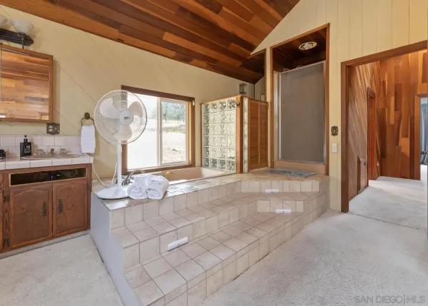 a spacious bathroom with a sink mirror and a bathtub