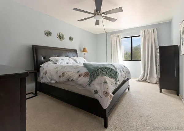 a bedroom with a bed lamp and a walk in closet
