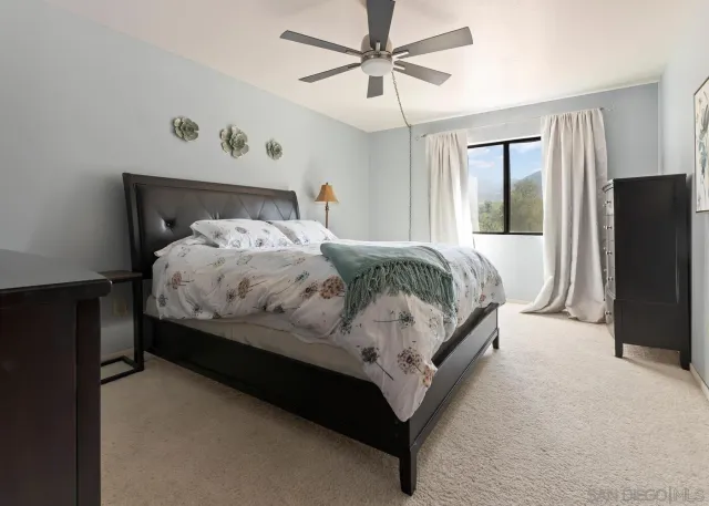 a bedroom with a bed lamp and a walk in closet