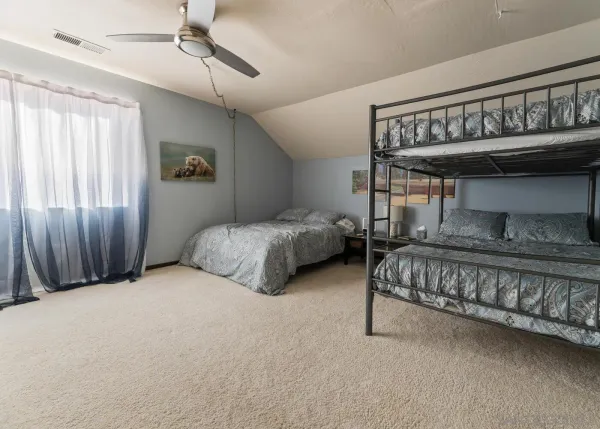 a bedroom with bed and window