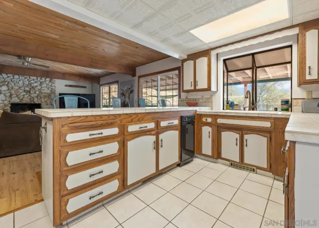 a kitchen with granite countertop a sink and cabinets
