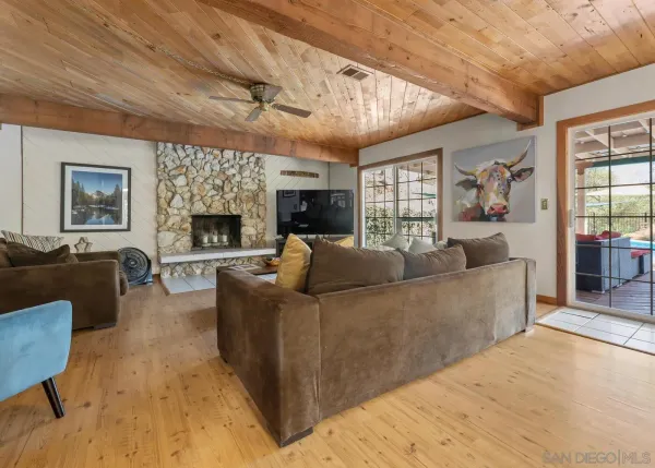 a living room with furniture flat screen tv and a fireplace