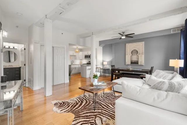 a living room with furniture and a wooden floor