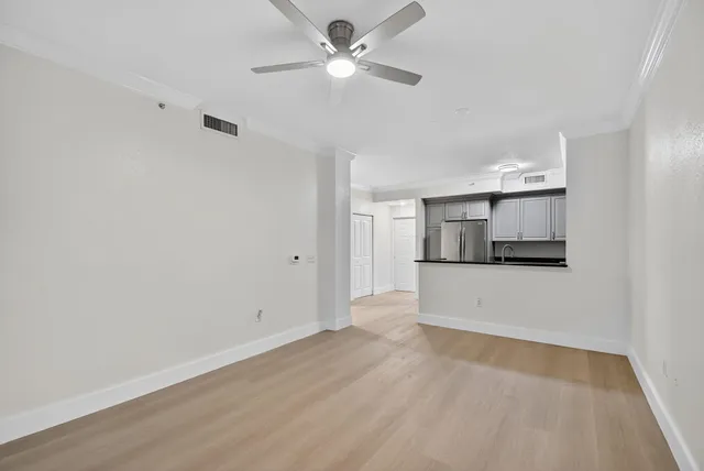 a view of a kitchen with a sink and a refrigerator